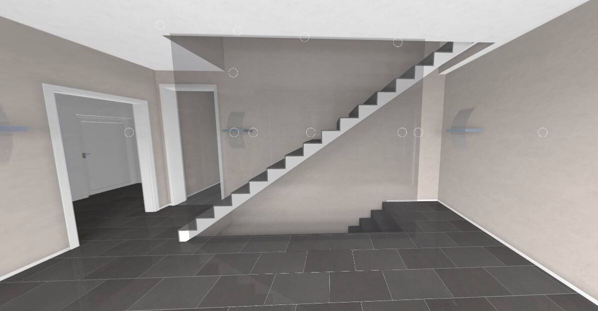 Moderne Innenhalle mit dunklen Bodenfliesen und diagonalem Treppenaufgang zur oberen Ebene.