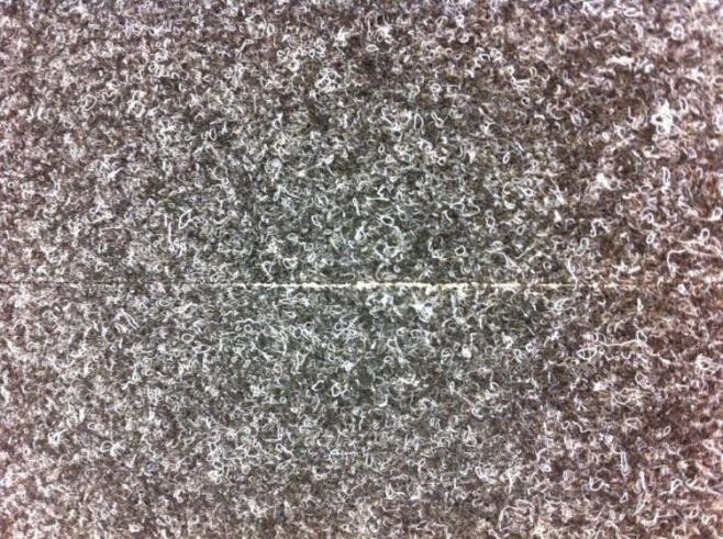 Nahaufnahme einer grauen Bodenbelag-Textur mit feiner Musterung