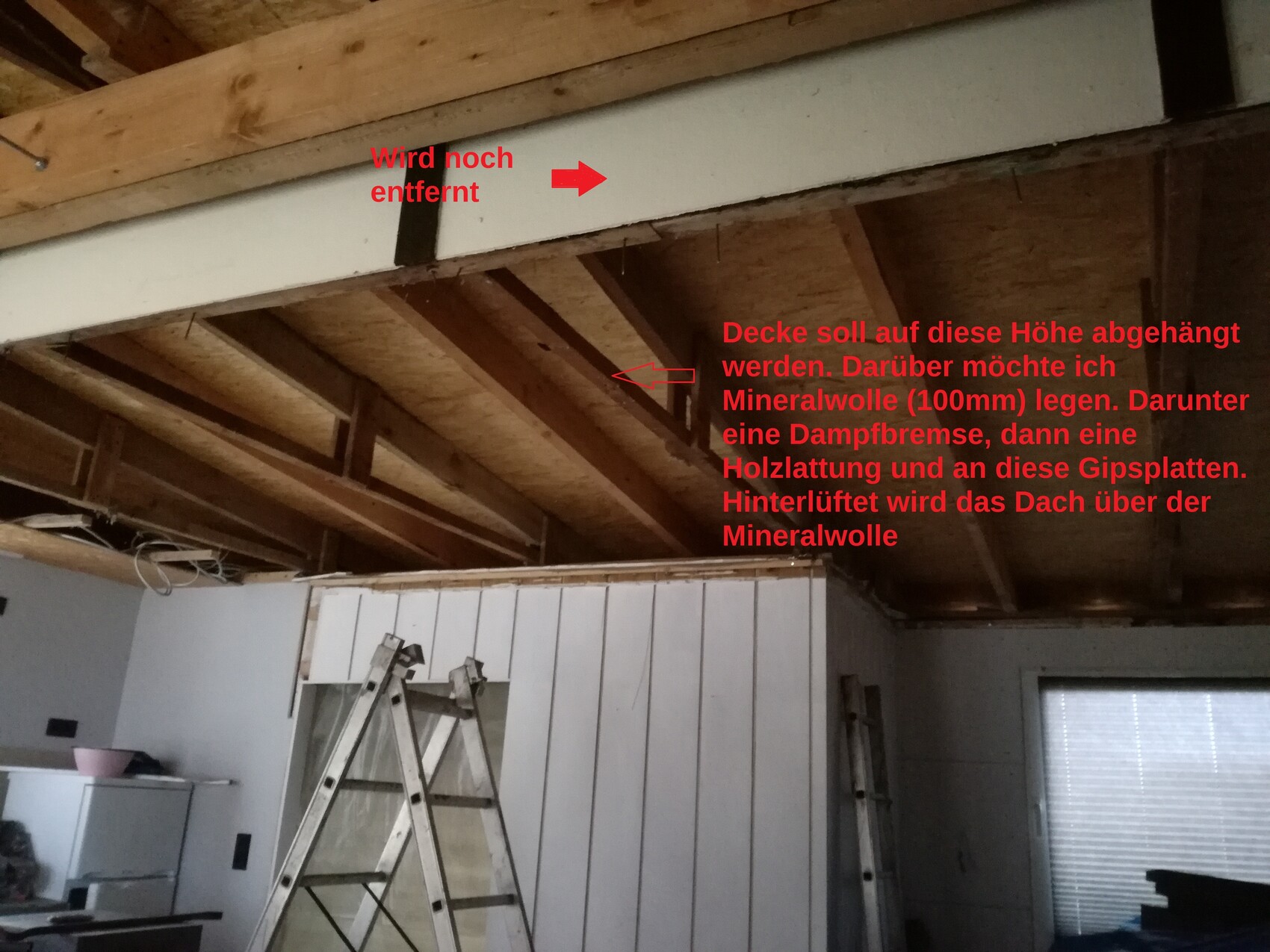 Innenraum mit offenen Dachbalken, Leiter und Bauarbeiten in Renovierungsphase.
