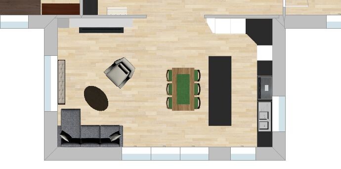Offener Wohnbereich mit Sofa, Sessel, runder Teppich, Esstisch und Küchenzeile auf Holzboden.
