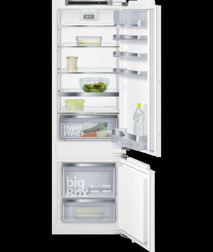 Großer weißer Kühlschrank mit offenen Türen und Gefrierfach unten; Regale und Lebensmittel sichtbar.