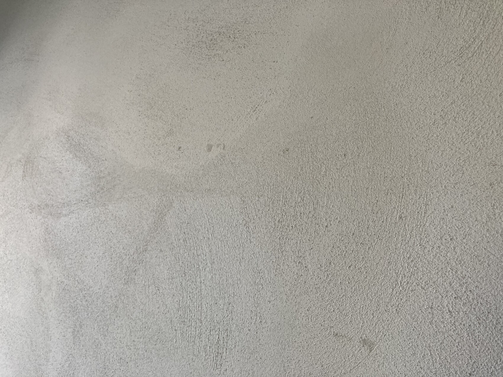 Raues, hellgraues Beton-/Putz-Oberflächenbild mit unregelmäßiger Textur