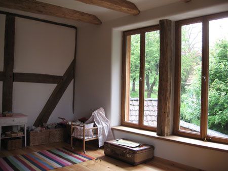 renoviertes-innenraum-mit-holzbalken-und-grossem-fenster.jpg