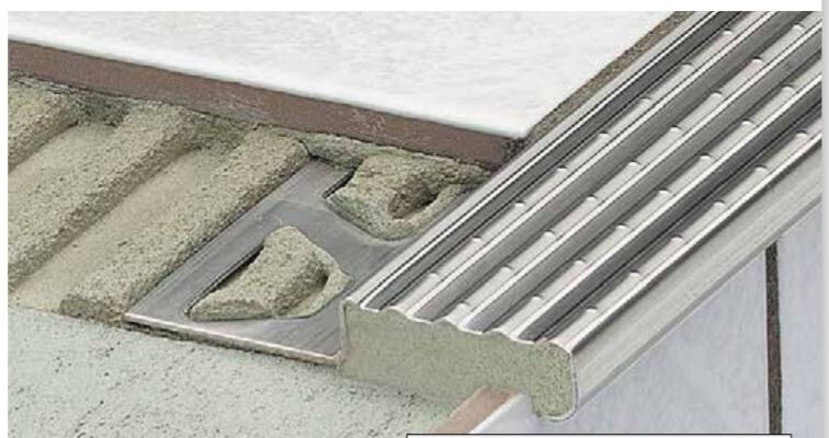 Metallrampenprofil mit rutschfester gerippter Oberfläche an einer Türschwelle.