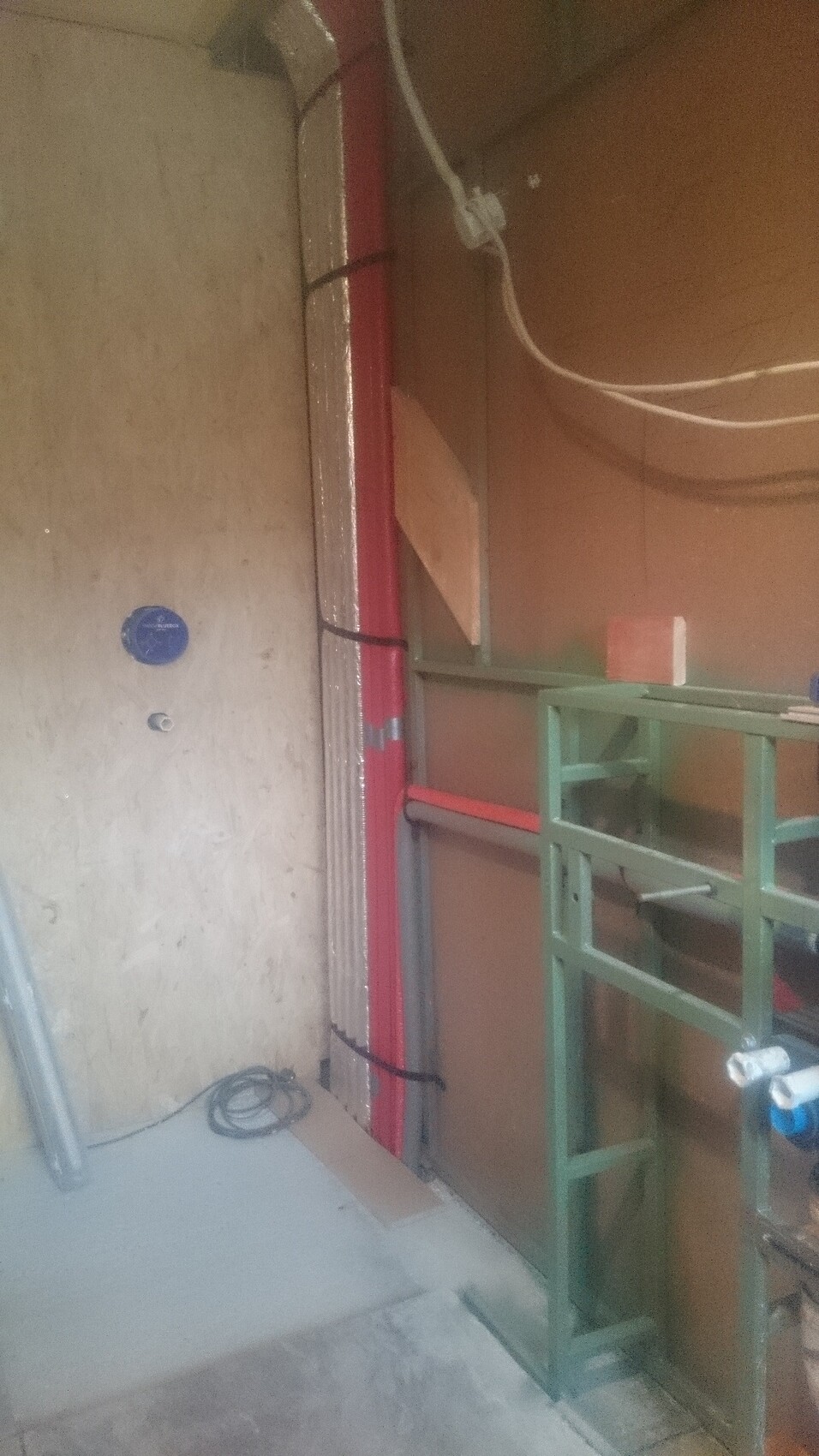 Innenansicht einer Baustelle mit Rohbau, Rohrleitungen und Elektroinstallation