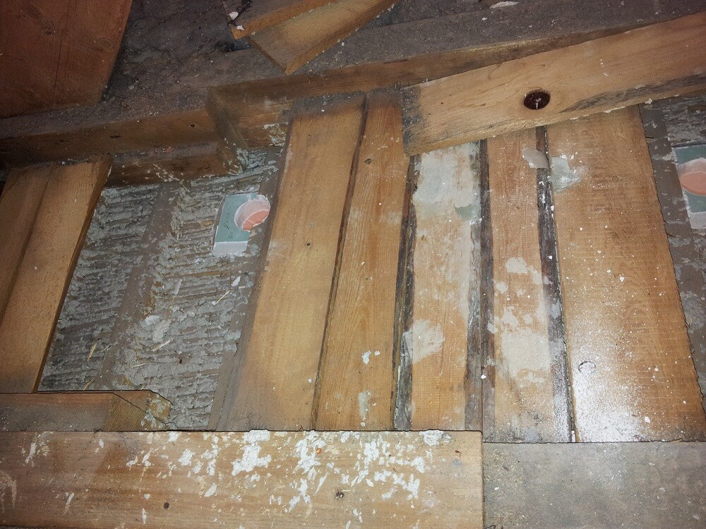 Unterkonstruktion aus Holzbalken im Rohbau, staubig und unfertig