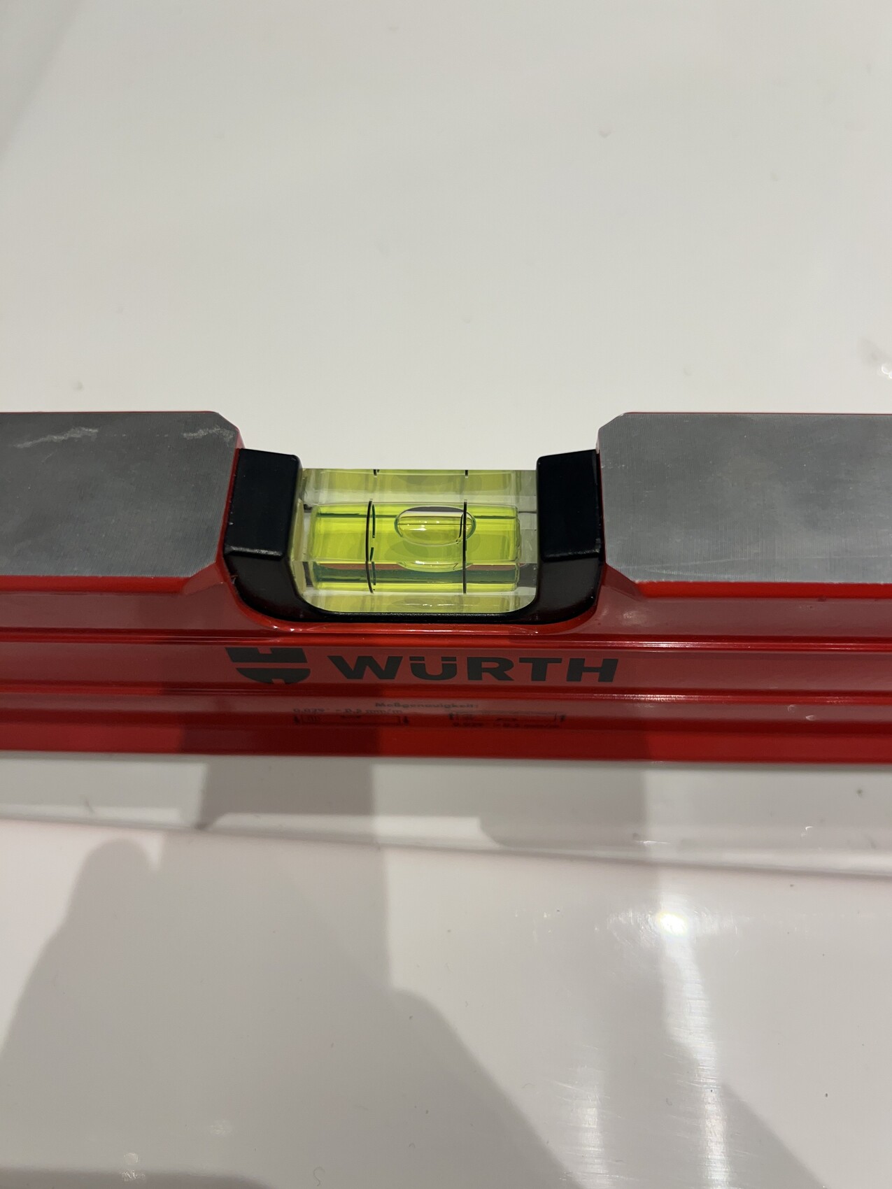 Rote Würth-Wasserwaage mit einer gelbgrünen Blase, Nahaufnahme.