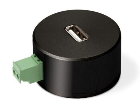 Runder schwarzer USB-Adapter mit USB-Port oben und grünem 2-poligem Klemmen-Anschluss seitlich.