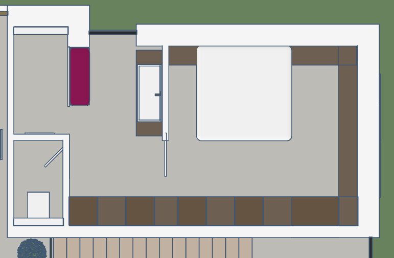 Grundriss eines Schlafzimmers mit Bett rechts, Kleiderschränken unten und Bad links.