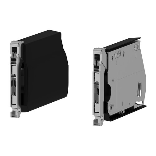 Zwei Ansichten eines modularen elektrischen Steckmoduls: schwarzes Gehäuse, rückseitige Anschlüsse.