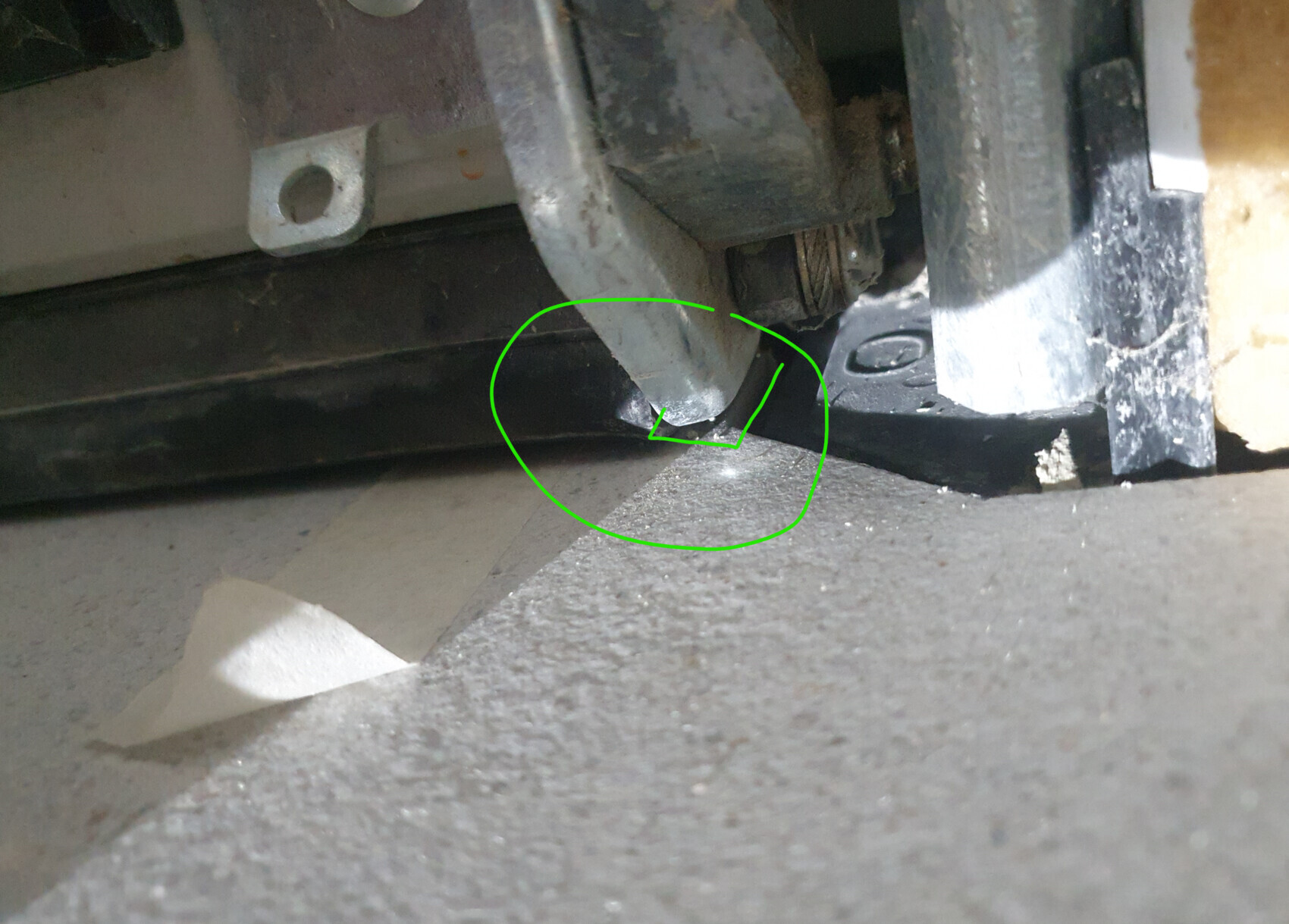 Nahaufnahme eines Metallwerkzeugs mit Schneide an einer Maschine, berührt den staubigen Boden.