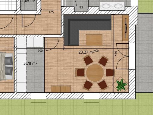Grundriss eines Wohn- und Esszimmers: runder Esstisch mit sechs Stühlen und Sofa.